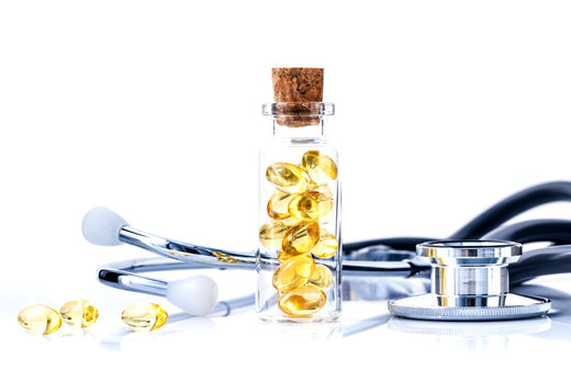 Glass jar filled with omega-3 fish oil capsules next to a stethoscope, symbolizing the medical and heart health benefits of dietary supplements.