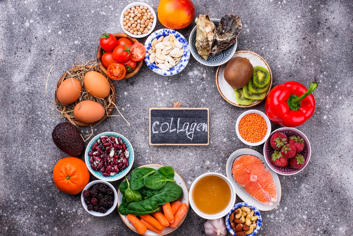 Assorted foods on a gray surface with a sign indicating 'Collagen'.