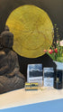 Supplement products with packaging and a Buddha statue on a table.