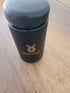 Black jar with 'Ballstad' logo on a wooden surface